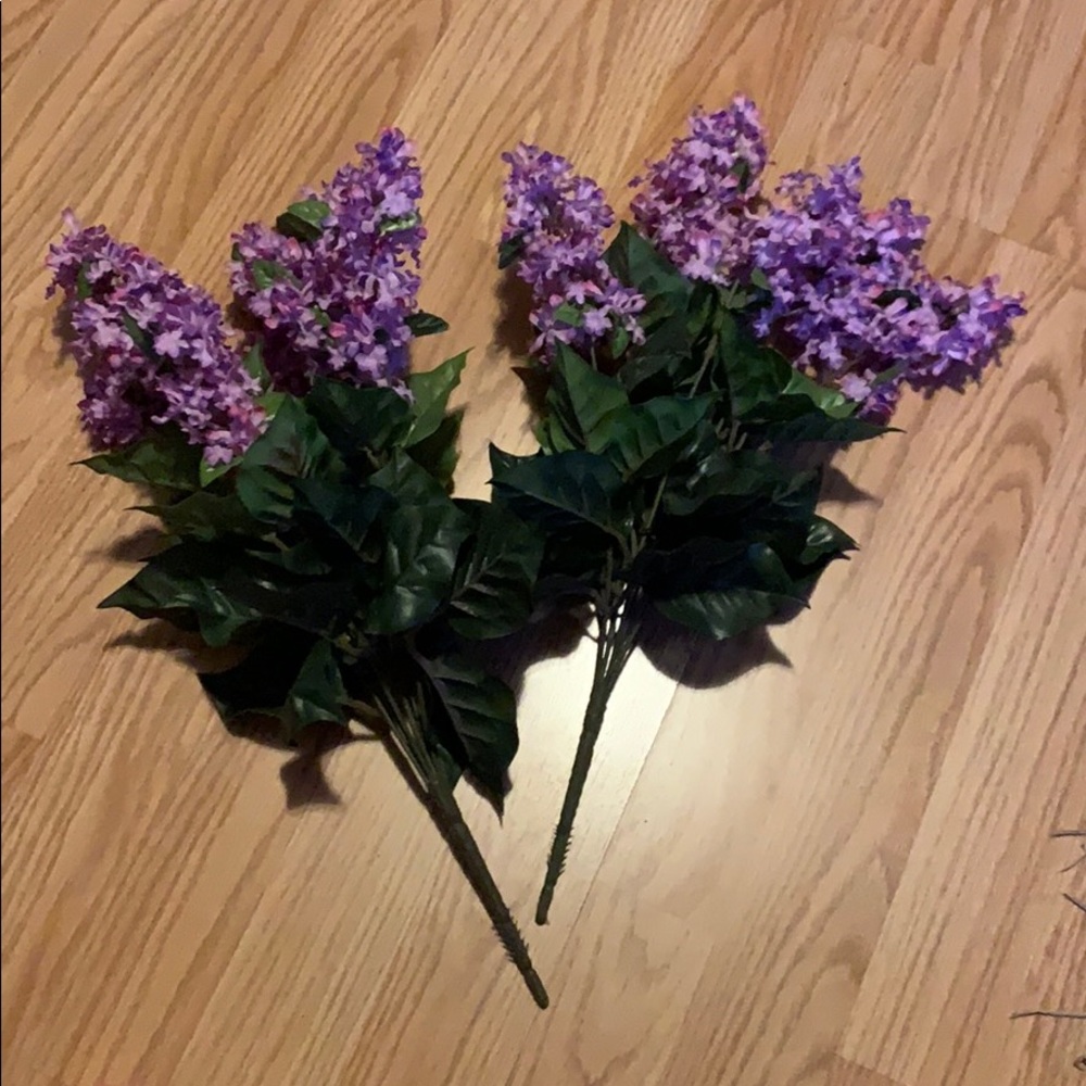 Faux purple flowers with green leaves